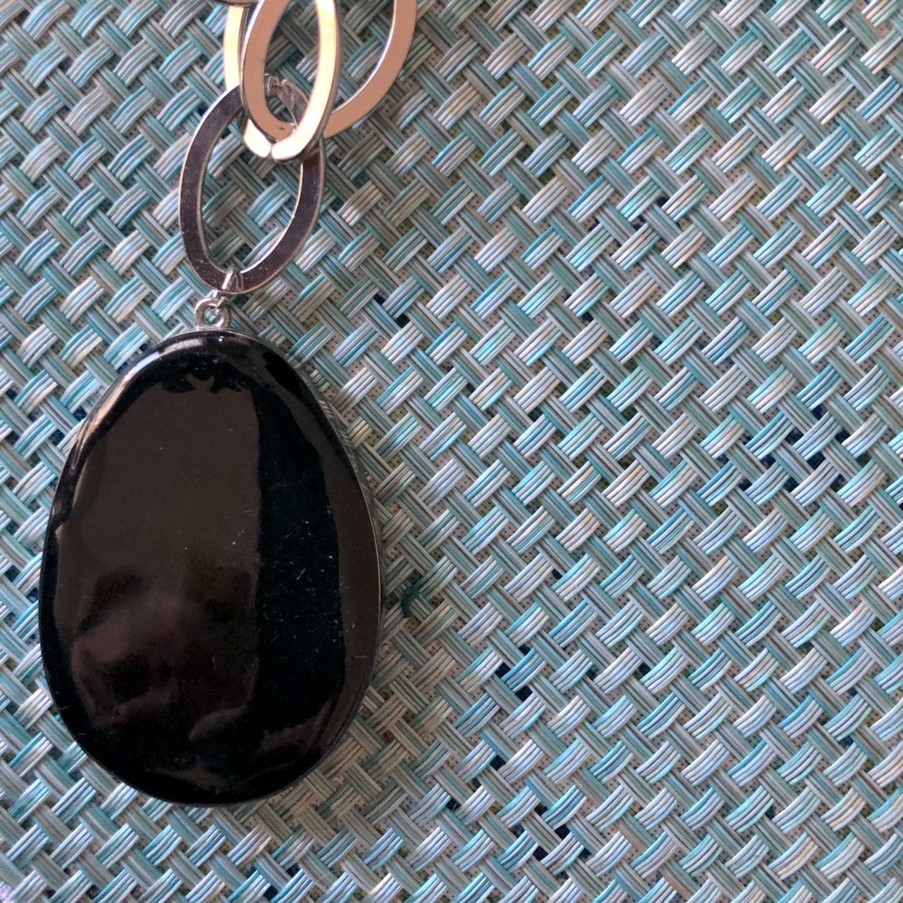 Large black stone, silver tone chain necklace.